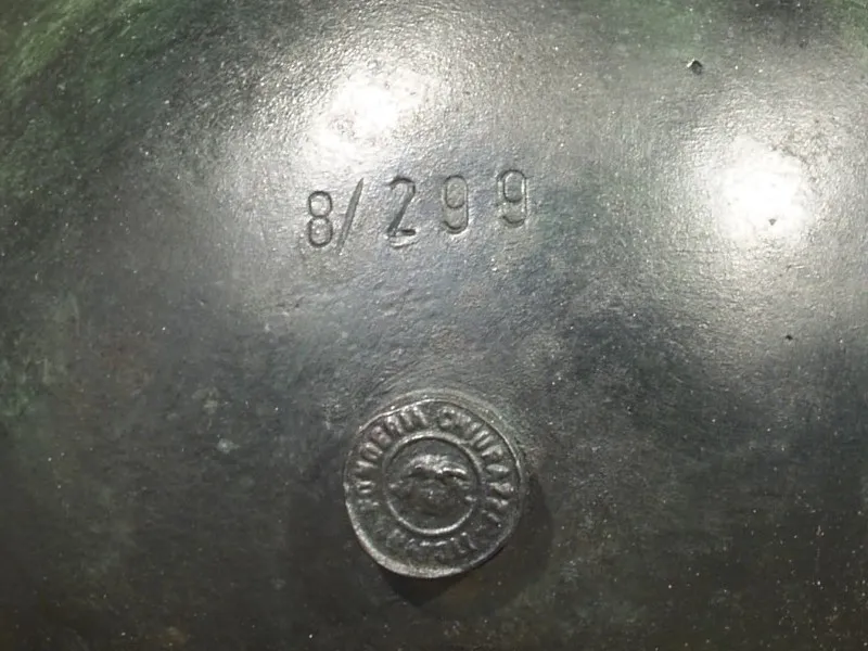 Close-up of the globe base of a Chiurazzi bronze, showing the edition number 8/299 and the round foundry seal.